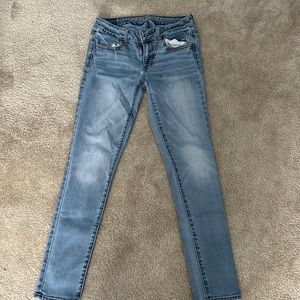 Light wash American Eagle skinny jeans.